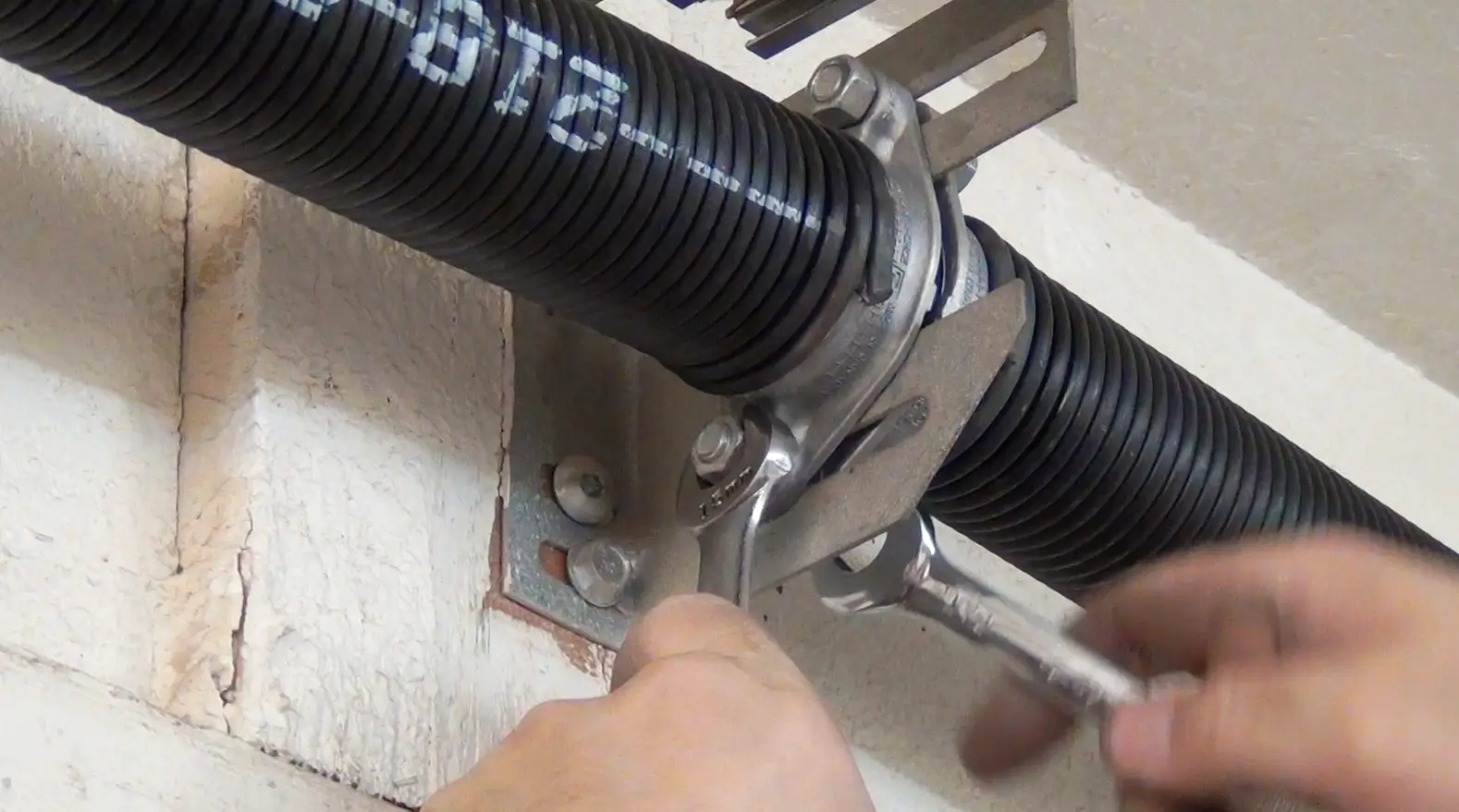 A technician replacing a garage door spring in Floresville